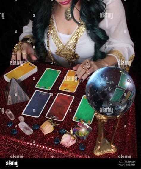 Female Psychic With Crystal Ball And Tarot Cards Shallow DOF Stock