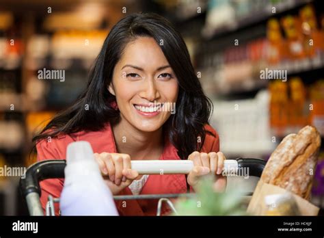 Happy Woman With Shopping Cart Stock Photo Alamy