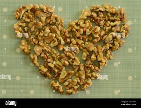 Peeled California Walnut Heart Stuffed On Blue Background With White