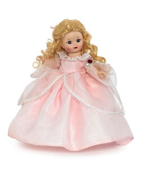 A Doll With Blonde Hair Wearing A Pink Dress