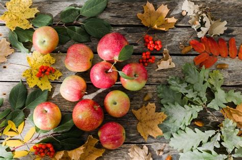 Premium Photo | Red apples scattered on the old wooden table with ...