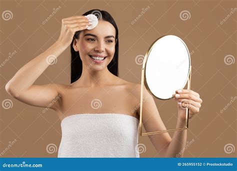 Attractive Brunette Woman Cleansing Face With Cotton Pad Holding