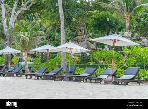 Beautiful Beach Chairs With Umbrella On Tropical White Sand Beach Stock