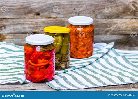 Glass Jars With Pickled Red Bell Peppers And Pickled Cucumbers Pickles