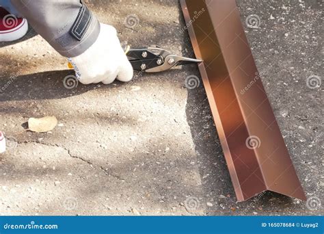 Worker Shears Sheet of Roofing Metal. Scissors for Metal Stock Photo ...