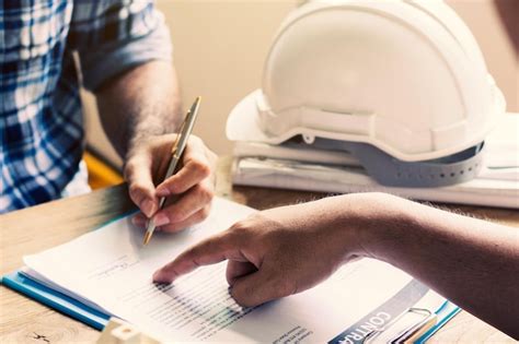 Premium Photo Midsection Of Engineers Working On Table