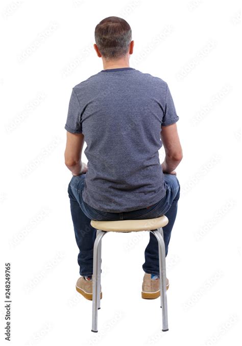 Back view of a man sitting on a chair. Stock Photo | Adobe Stock