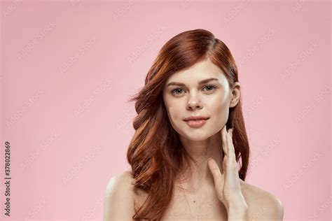 Pretty Woman With Long Beautiful Hair Grooming Hairstyle Glamor Naked Shoulders Pink Background