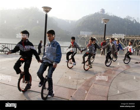 Kids On Unicycles A Group Of Kids Take A Leisurely Ride On Their