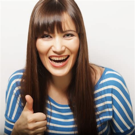 Premium Photo Young Woman Showing Thumbs Up Gesture