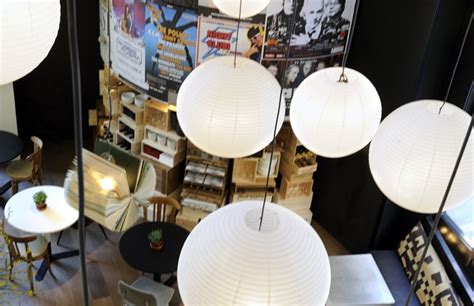 An Overhead View Of Several Lamps And Tables In A Room With Posters On