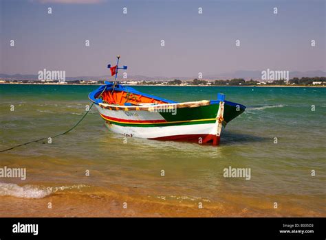 Fishing Boat On The Beach Outside The Old Fort Hammamet Tunisia Stock