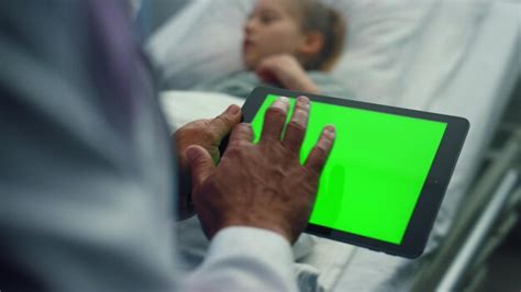 Premium Photo | Doctor touching tablet green screen closeup Sick girl ...