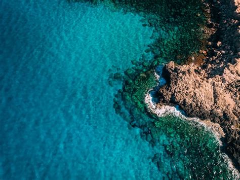 Premium Photo Aerial Overhead Rocky Seashore With Crystal Clear Blue