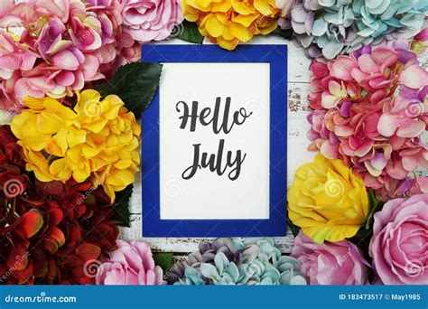 Hello July Card With Colorful Flowers Border Frame On Wooden Background