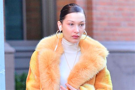 Bella Hadid Makes A Chic Statement In Fluffy Orange Coat And Chunky Retro