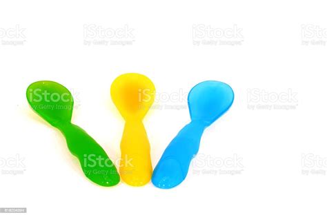 Colored Plastic Spoon For Children On White Background Stock Photo