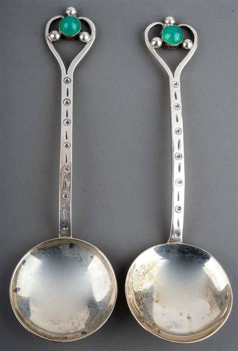 A Pair Of Arts Crafts Silver Spoons Stylised Heart Shaped Openwork