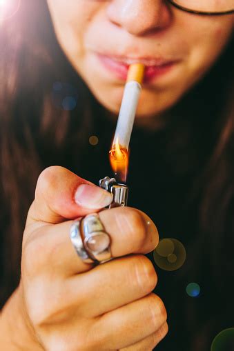 Young Adult Woman Lighting Her Cigarette Stock Photo - Download Image ...