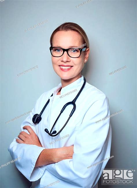 Portrait Of Smiling Female Doctor With Stethoscope Wearing Glasses