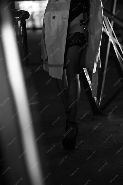 Premium Photo | Sexy female legs in stockings and a raincoat black and