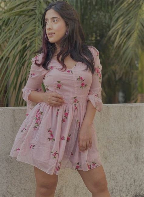 A Woman In A Pink Dress Posing For The Camera