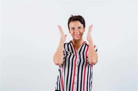 Free Photo Mature Woman Holding Hands Near Head Smiling In Striped