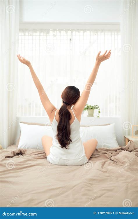 Asian Woman Stretching In Bed After Wake Up Back View Stock Image