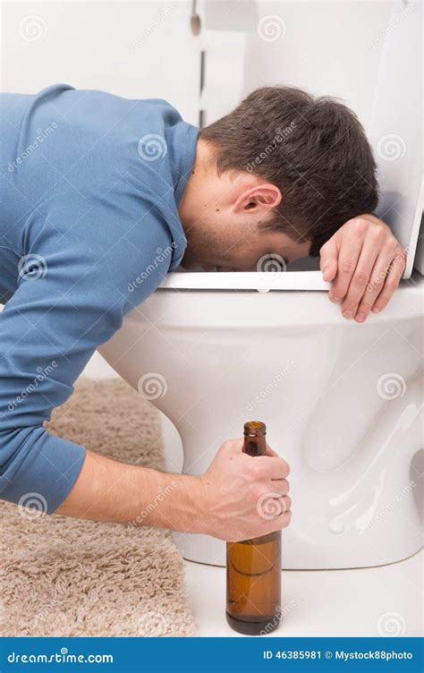 Drunk Man Sleeping On Toilet And Holding Bottle Royalty Free Stock