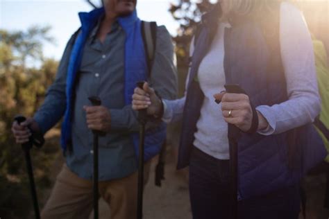 Senior Couple Hiking With Nordic Walking Sticks In Mountains From Pikwizard