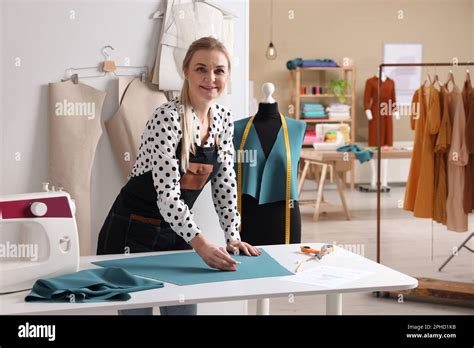 Dressmaker Marking Fabric With Chalk In Workshop Stock Photo Alamy