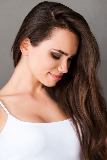 Premium Photo Natural Beauty Beautiful Young Woman In White Tank Top Looking Down