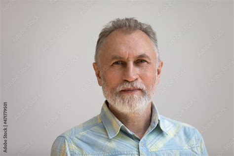 Serious older man in casual with beard head shot portrait. Grey haired ...