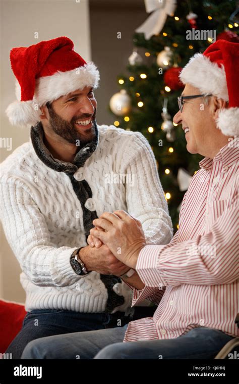 Grandson And Grandfather Together Holding Hands For Christmas Stock