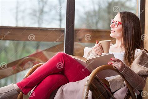 Woman Sitting On Chair Reading Book At Home Stock Image Image Of