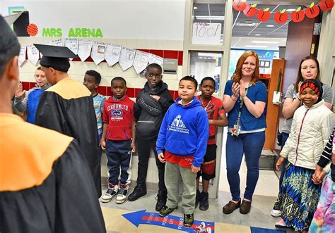 Henninger Seniors Look To Inspire Young Students With Cap And Gown Walk