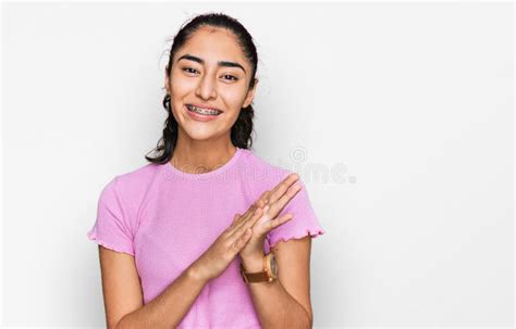 Hispanic Teenager Girl With Dental Braces Wearing Casual Clothes