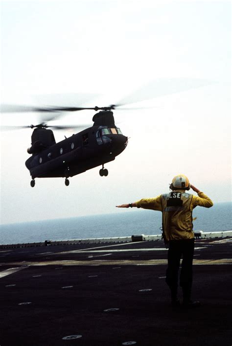 A Flight Deck Crewman On The Directs An US Army CH 47D Chinook