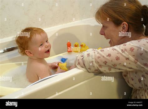 A Baby Being Bathed By His Mother Stock Photo Alamy