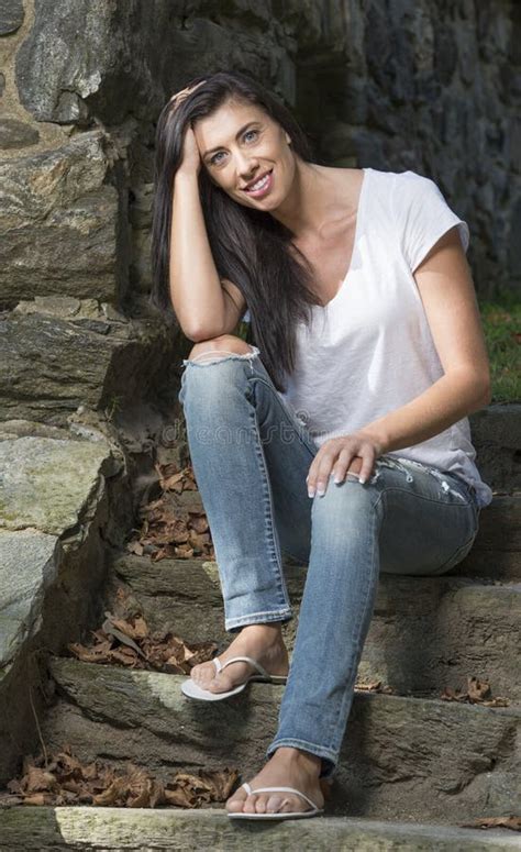 Beautiful Brunette Woman Standing In White T Shirt And Jeans Garden Stock Photo Image Of