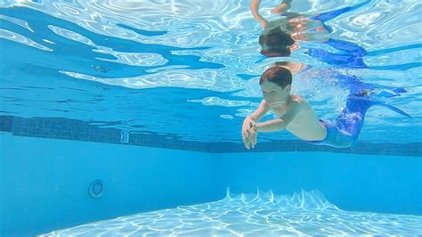 A Boy Swimming Underwater with a Mermaid Tail · Free Stock Video