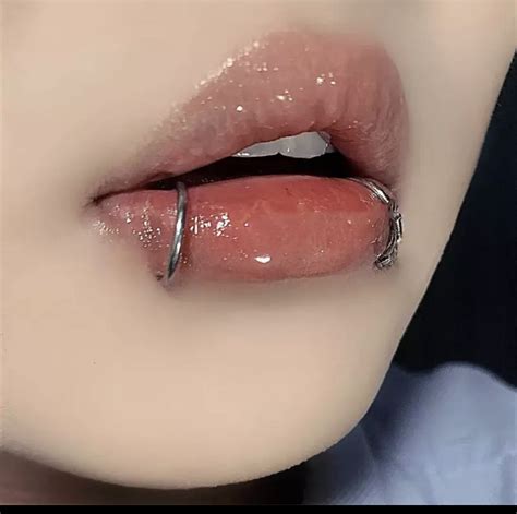 A Close Up View Of A Woman S Lips And Lip Ring With Glitter On It