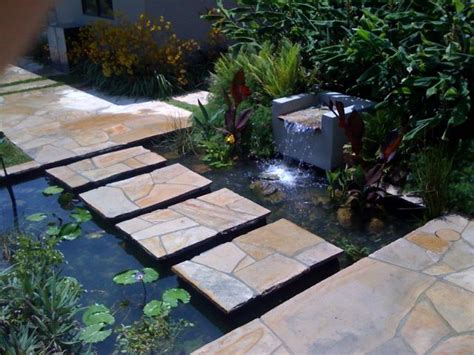 A Stepping Stone Path Across A Pond In Malibu Ponds Backyard Garden