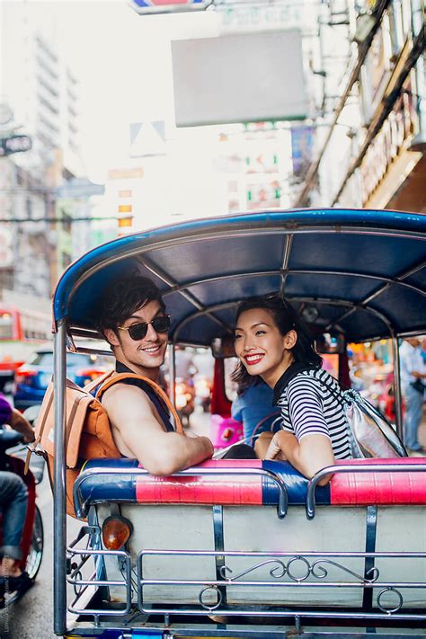 Couple Riding In A Tuk Tuk Taxi In Bangkok By Stocksy Contributor