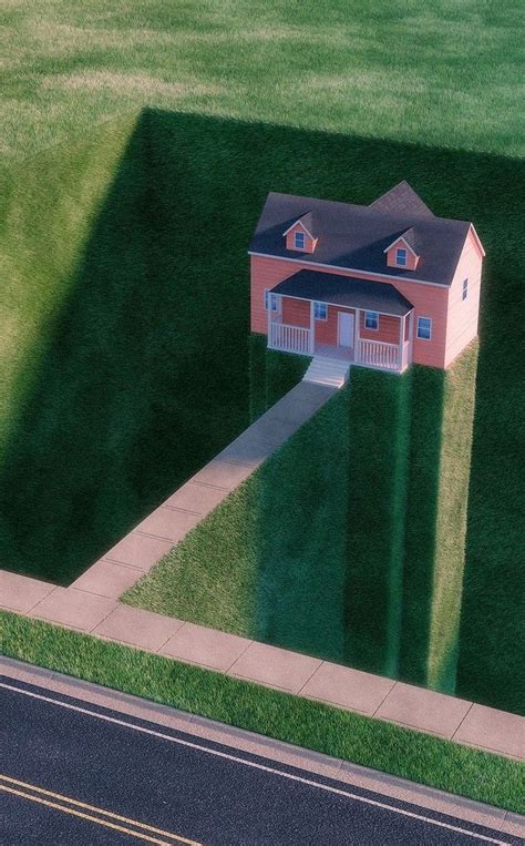 An Aerial View Of A House In The Middle Of A Grassy Area With A Road