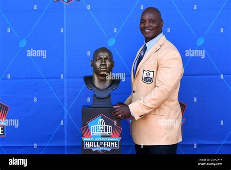 Former NFL player Bryant Young poses with his bust during an induction ...