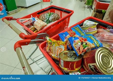 Grocery Baskets With Food Products On Carts In Auchan Supermarket