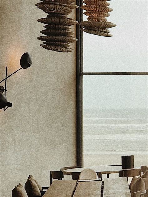 A Dining Room Table And Chairs With An Ocean View