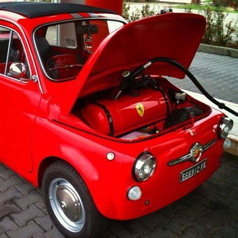 An Old Red Car With Its Hood Open