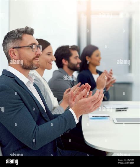 Heres To Celebrating Success A Group Of Businesspeople Clapping Their